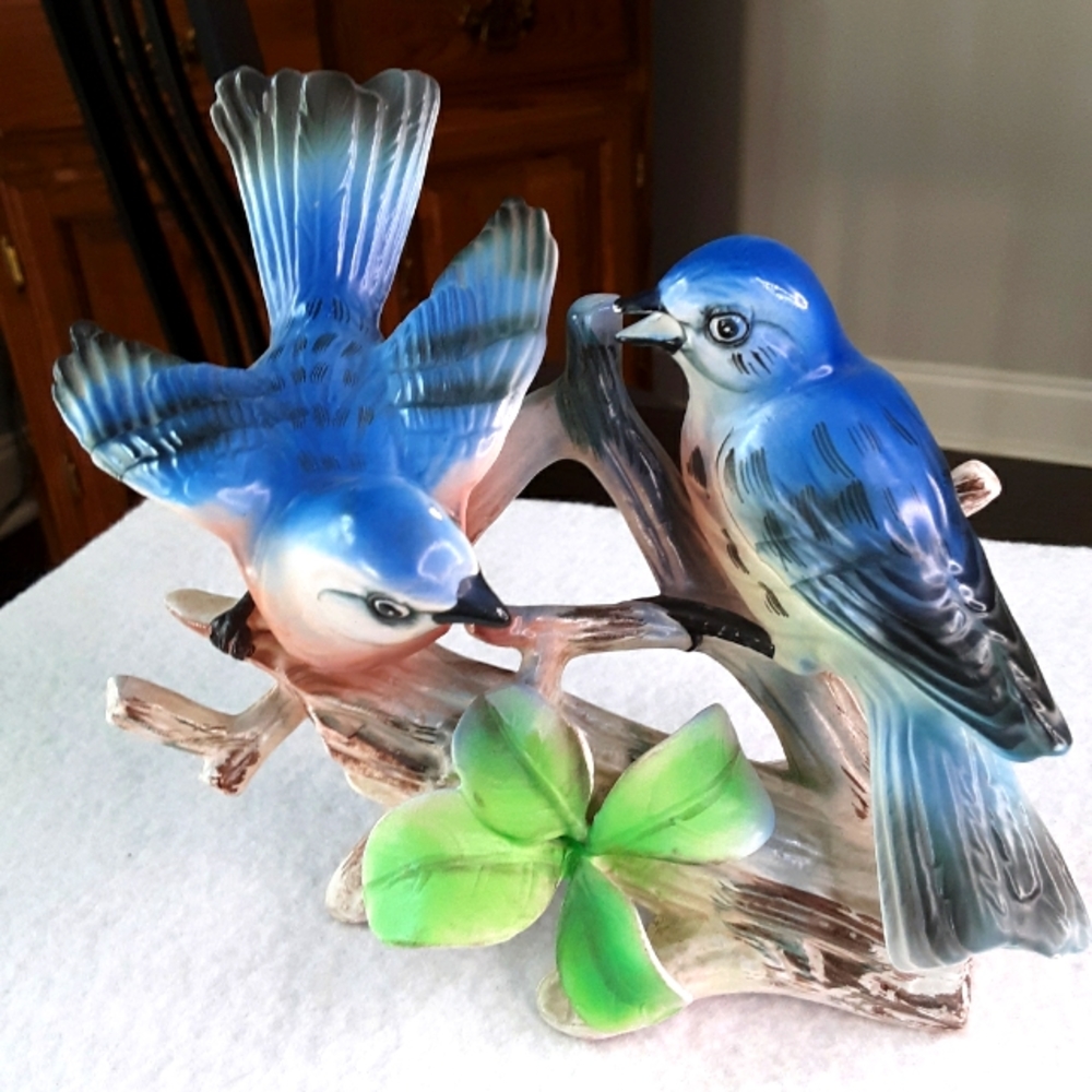 Collectible figurine Blue Jays resting on tree branch.